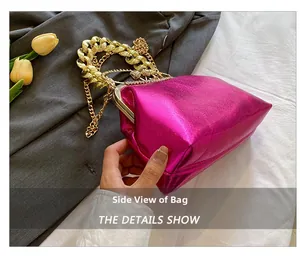 Side view of rose red glossy evening bag with chunky gold chain handle and tulips