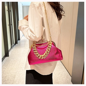 Magenta metallic clutch bag with chunky gold chain detail and shiny rhinestone clasp