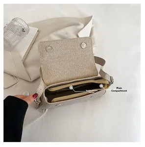 Internal view of beige woven handbag showing spacious main compartment and phone pocket