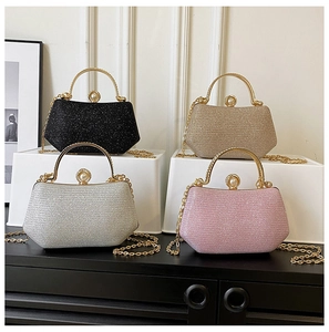 Detailed view of sparkly glitter clutch bags with metal handles and pearl clasps in four colors