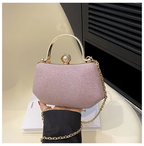 Detail of light pink sequin evening bag with gold rhinestone handle and pearl clasp