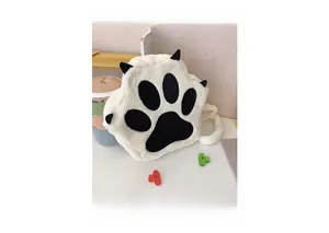 Detail of white plush cat paw backpack showing soft faux fur and black claw accents