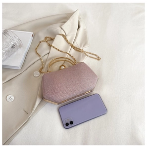 Pink glitter evening bag with gold pearl handle and chain compared to a smartphone