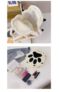 Detail view of white plush cat paw backpack showing internal pockets and large storage space