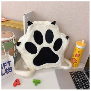 Detailed view of the plush cat paw backpack featuring soft faux fur and black claw embroidery