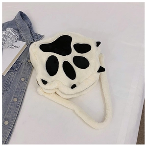 Detail of the soft plush cat paw crossbody bag with cute black paw pads and metal zipper