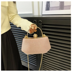Pink glitter evening bag with gold metal handle and large pearl clasp detail