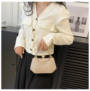 Champagne glitter evening bag with pearl clasp and metal chain shown on model