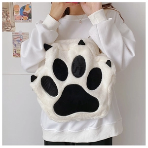 Detail shot of plush cat paw shoulder bag showing soft fur texture and black claw pads