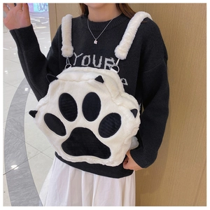 Detail of soft white plush cat paw backpack showing fluffy texture and silver buckles