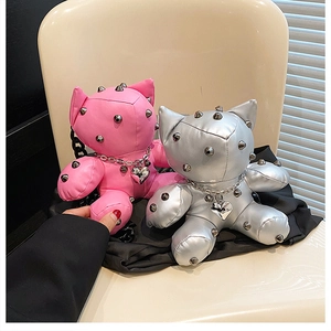 Detail of punk style bear bags in pink and silver with metal spikes and heart charms