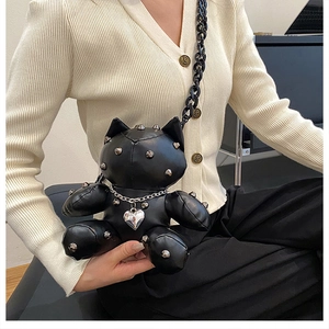 Detail of creative cat-shaped black punk bag with silver studs and heart pendant