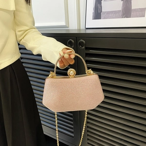 Pale pink rhinestone evening bag with golden round handle and detachable chain strap