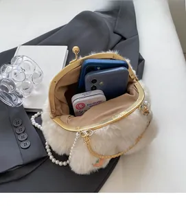 Interior view showing the capacity of a white plush rabbit bag with two mobile phones