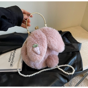 Detail of pink plush rabbit bag featuring soft faux fur texture and elegant pearl strap