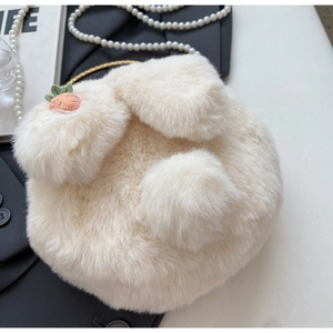 Close-up of white plush bunny ear bag with carrot embroidery and soft faux fur texture