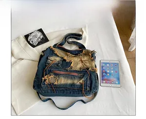 Detailed top view of vintage denim tote bag with patchwork and frayed edges