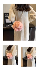 Detail of pink plush bunny bag with soft rabbit ears and elegant white pearl shoulder strap