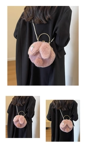 Detail of pink plush rabbit bag featuring soft faux fur texture and elegant pearl chain