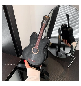 Detailansicht der kreativen Umhängetasche in Violinenform auf rustikalem Holzgrund