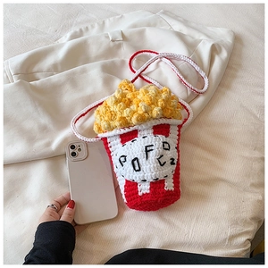 Close-up of handmade popcorn bucket knit bag featuring red stripes and yellow texture