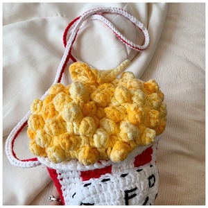 Detailed close-up showing the handmade crochet texture of the popcorn bucket bag