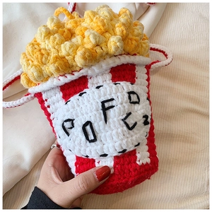 Close-up of handmade crochet popcorn bag with 3D texture and popcorn text embroidery