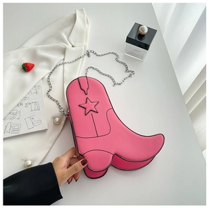 Detailed view of pink boot-shaped handbag with star patterns and silver chain strap