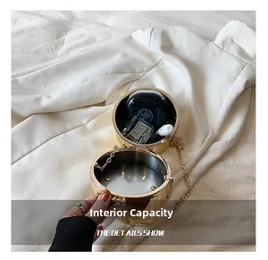 Interior view of gold cylindrical evening bag showing space for cosmetics and luxury chain