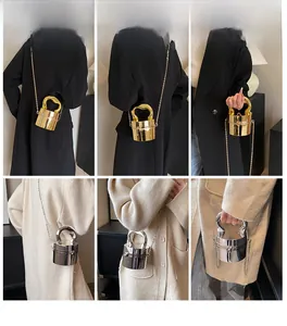 Chic cylindrical metal mini bag with chain strap and U-shaped handle on a model