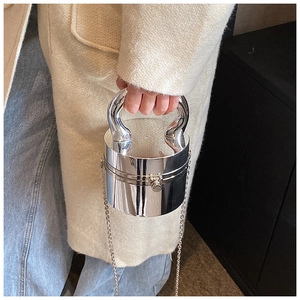 Close-up of silver cylinder handbag with mirror-finish metal and elegant sphere clasp