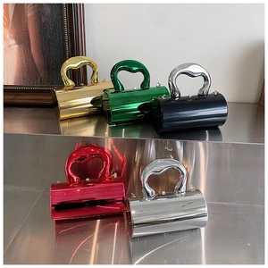 Detail of mirror acrylic clutch bags with luxury heart-shaped metal handles in multiple colors