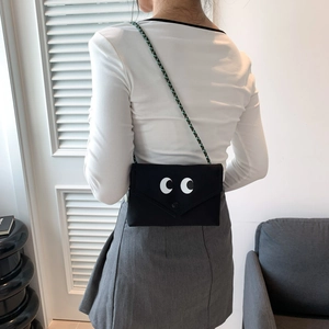 Sac bandoulière en toile noire avec imprimé yeux et sangle tressée verte pour femmes
