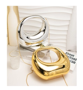 Detail von metallischen Acryl-Clutch-Taschen in Gold und Silber mit skulpturalem Design