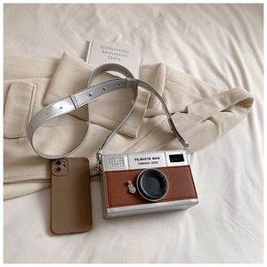 Close-up of vintage camera-style silver and brown crossbody bag with lychee texture