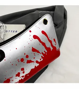Close-up of silver PU leather bag featuring creative red splatter paint and metal eyelet