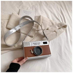 Detailed view of creative retro camera-shaped crossbody bag with silver and brown leather