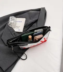 Spacious interior of white cleaver bag showing smartphones and daily essentials