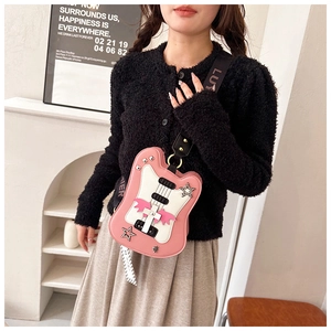 Detail of pink electric guitar crossbody bag with metal rivets and wide strap
