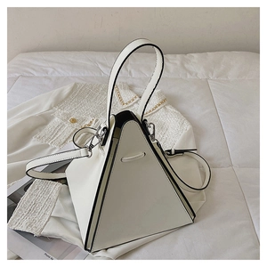 Detail of white triangle handbag showing contrast black edges and silver metal hardware