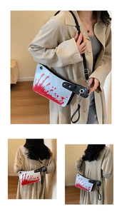 Detail view of the creative meat cleaver crossbody bag with realistic blood splatters