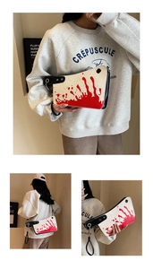Macro detail of creative cleaver shaped PU handbag with red blood splatter design patterns