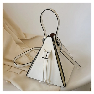 Detailed view of white pyramid bag with drawstring knot and black edge finishing