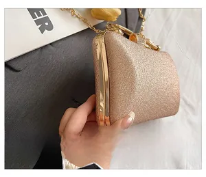 Detail showing the side view of the gold sequined evening bag with metallic trim