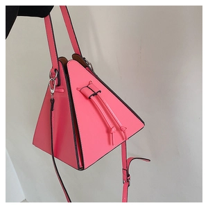 Detailed close-up of pink triangular PU leather handbag with drawstring and dual handles
