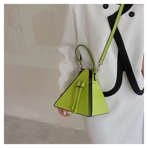 Close-up of a vibrant neon green triangular PU leather handbag with drawstring detail