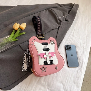 Creative pink guitar-shaped crossbody bag with star patches and wide branded strap