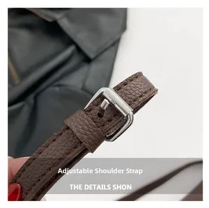 Macro shot of adjustable dark brown lychee texture leather strap with silver metal buckle