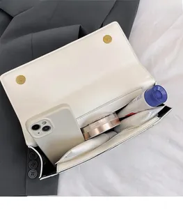 Interior view showing the large capacity of the white leather crossbody bag and magnetic clasp