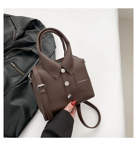 Detail of creative shirt-shaped crossbody bag in dark coffee lychee leather with rivets
